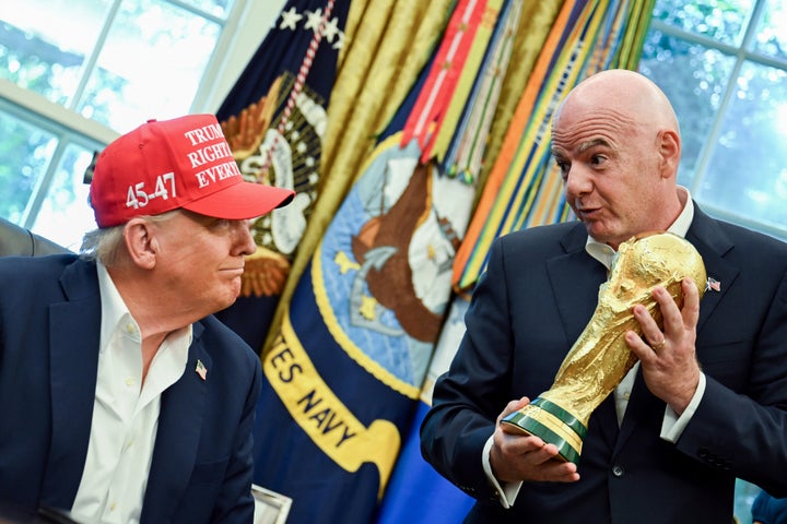 U.S. President Donald Trump (left) and Gianni Infantino, president of the Federation International Football Association, are seen with the FIFA World Cup trophy in the Oval Office of the White House in August.