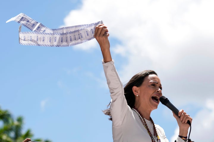 Opposition leader Maria Corina Machado displays vote tally sheets during a protest against the reelection of President Nicolás Maduro one month after the disputed presidential vote which she says the opposition won by a landslide, in Caracas, Venezuela, on Aug. 28, 2024.