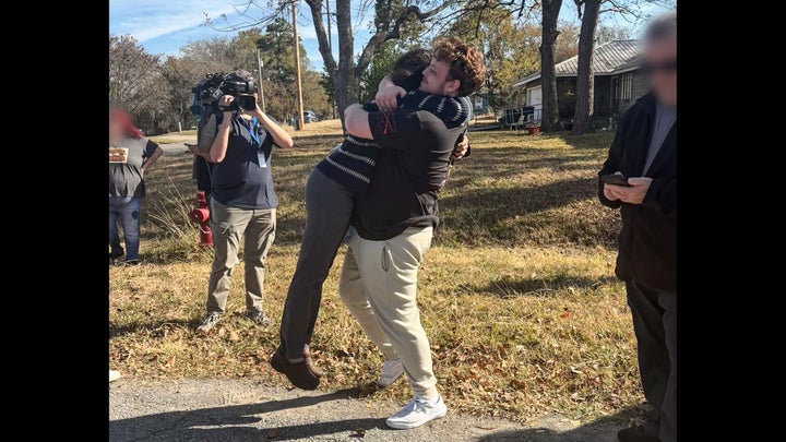 Amanda Bass Castro Alves with Tremane Wood's son Tremane Wood Jr. moments after the clemency announcement.