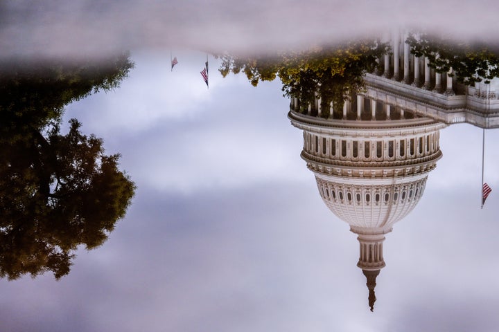The U.S. Capitol is reflected in a puddle outside of the Rayburn House Office Building, Wednesday, July 16, 2025, on Capitol Hill in Washington. (AP Photo/Julia Demaree Nikhinson)