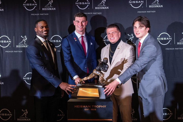 Heisman Trophy finalists, from left to right, Notre Dame running back Jeremiah Love, Indiana quarterback Fernando Mendoza, Vanderbilt quarterback Diego Pavia and Ohio State quarterback Julian Sayin pose with the trophy after attending an NCAA college football news conference before the award ceremony, Saturday, Dec. 13, 2025, in New York. (AP Photo/Eduardo Munoz Alvarez)