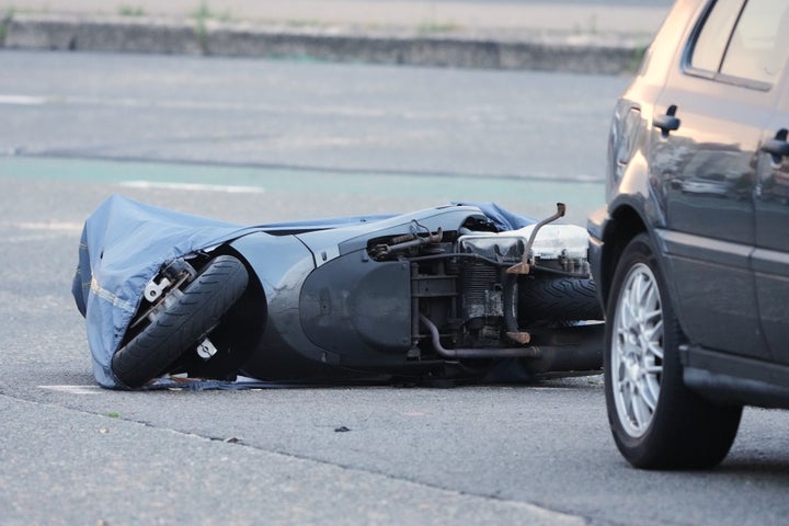 A motorcycle lies on the ground in the early morning near the site of a shooting Sunday at Sydney's Bondi Beach, Monday, Dec. 15, 2025. (AP Photo/Mark Baker)