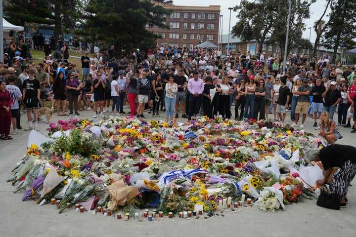 People gather around a tribute for shooting victims outside the Bondi Pavilion at Sydney's Bondi Beach, on Dec. 15, 2025, a day after a shooting.