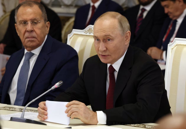 Russian President Vladimir Putin (R) with Foreign Minister Sergey Lavrov (R)