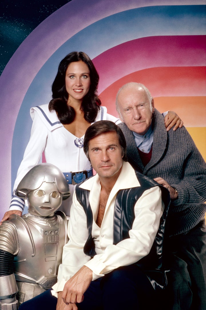 Gil Gerard, center, with co-stars Felix Silla as the robot Twiki, Erin Gray and Wilfrid Hyde-White in the second season of “Buck Rogers in the 25th Century.”