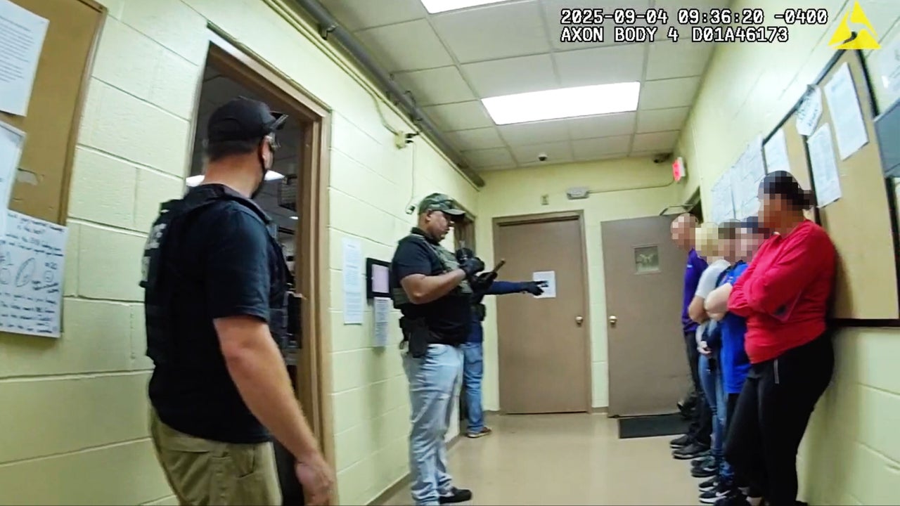 A federal agent addresses managers and supervisors at Nutrition Bar Confectioners in Cato, New York on Sept. 4, 2025.