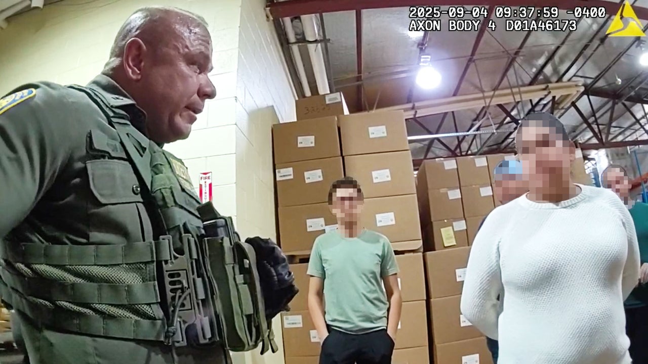 A federal agent questions a woman at Nutrition Bar Confectioners in Cato, New York, on Sept. 4, 2025.