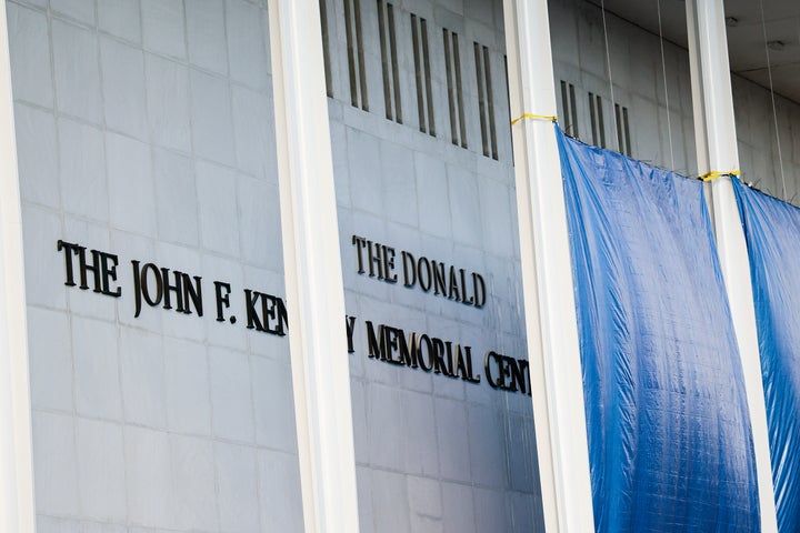 Workers adjust the name of the John F. Kennedy Memorial Center for the Performing Arts on Friday in Washington, D.C.