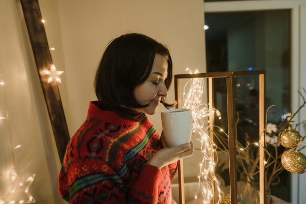Woman Wearing Red Sweater Holding a Mug