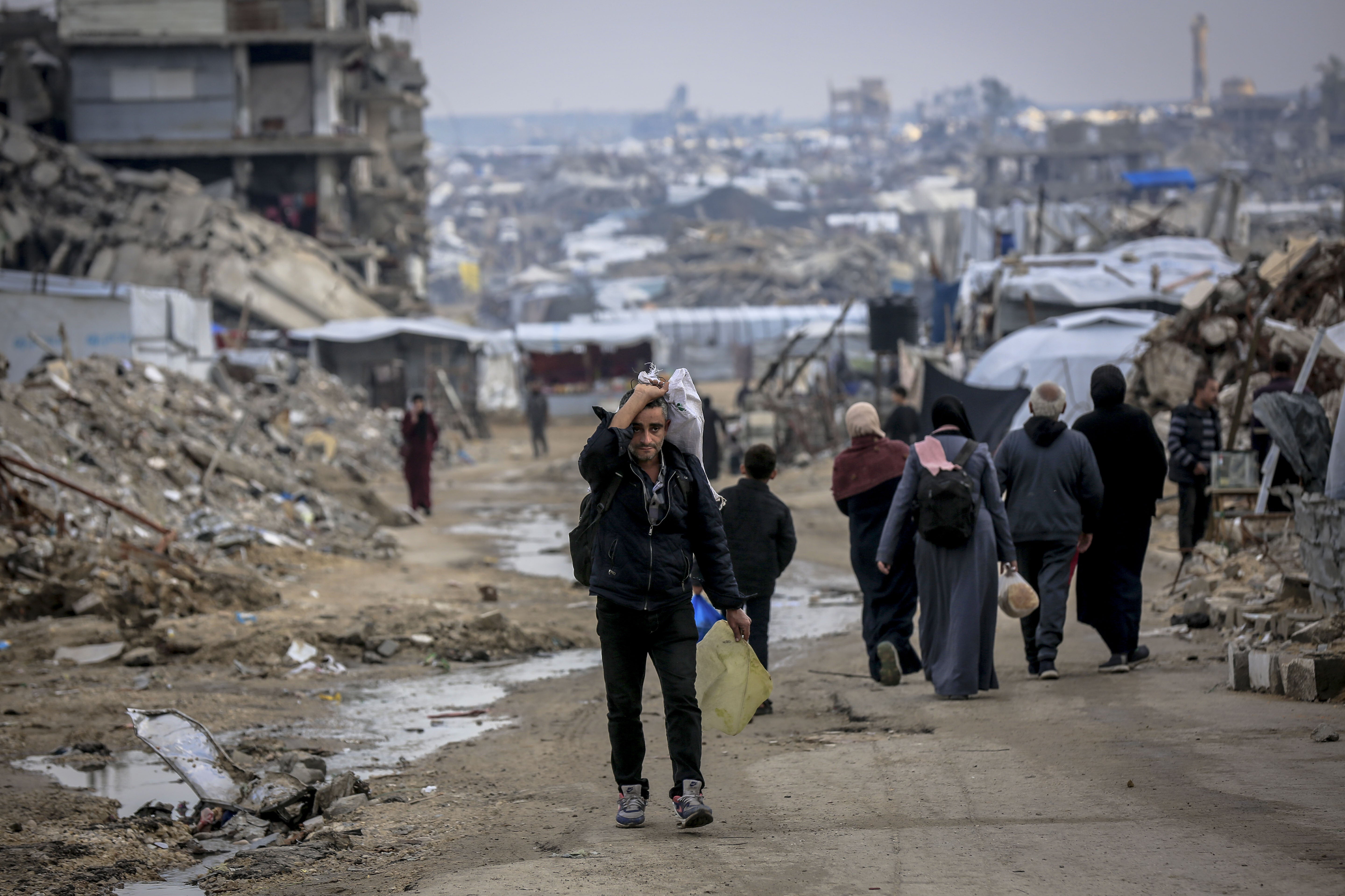 Palestinians living in makeshift tents try to continue their daily lives under difficult conditions amid the rubble left behind by Israeli attacks in Gaza City, Gaza on December 19, 2025. (Photo by Saeed M. M. T. Jaras/Anadolu via Getty Images)