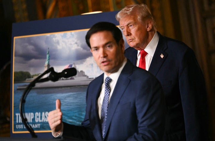 President Donald Trump looks on as Secretary of State Marco Rubio speaks about the US Navy's new Golden Fleet initiative in Palm Beach, Florida, on December 22, 2025. (Photo by ANDREW CABALLERO-REYNOLDS / AFP via Getty Images)