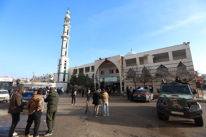 Security officers and members of the press gather outside Imam Ali ibn Abi Talib Mosque following an explosion in the Wadi al-Dahab neighborhood of Homs on December 26, 2025. (Photo by Omar HAJ KADOUR / AFP via Getty Images)