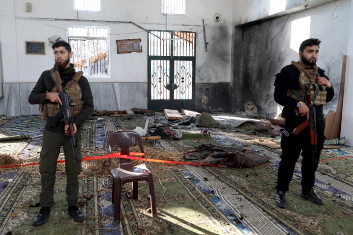 Armed security officers cordon off the area following an explosion inside Imam Ali ibn Abi Talib Mosque in the Wadi al-Dahab neighborhood of Homs on December 26, 2025. (Photo by Omar HAJ KADOUR / AFP via Getty Images)