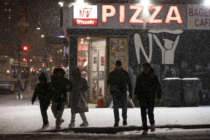 People cross the street as snow falls during a winter storm in New York City, U.S., December 26, 2025. (Photo by Mostafa Bassim/Anadolu via Getty Images)