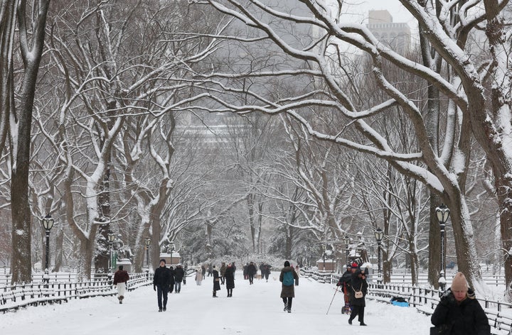 People walk in the snow in Central Park in New York City on December 27, 2025. (Photo by TIMOTHY A. CLARY / AFP via Getty Images)