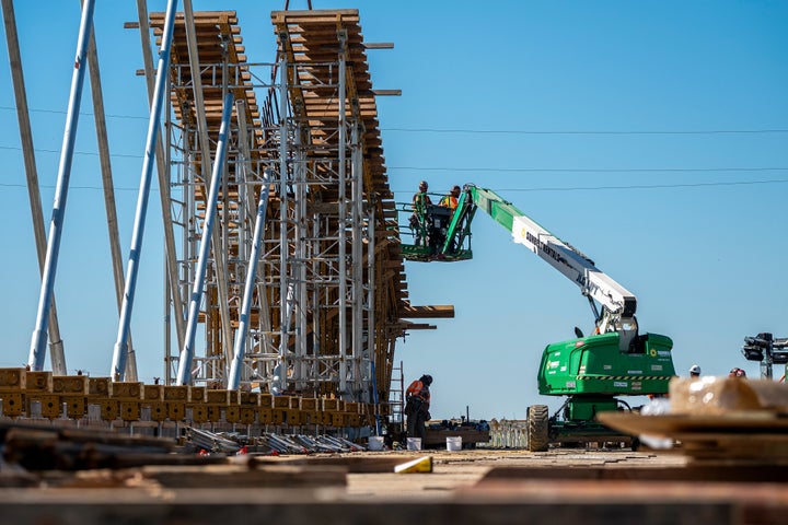 Contractors on a cherry picker during the construction of a high-speed rail project in Kings County, California, US, on Monday, March 24, 2025.(David Paul Morris/Bloomberg via Getty Images)