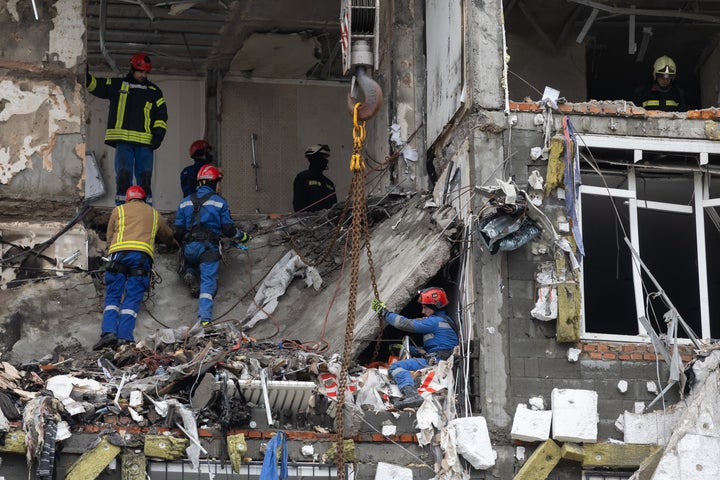 Rescue workers remove the rubble of an 18-story residential building in the Dniprovskyi district, destroyed from the 3rd to 5th floors by a Russian drone strike on December 27, 2025 in Kyiv, Ukraine. (Photo by Yevhenii Zavhorodnii/Global Images Ukraine via Getty Images)