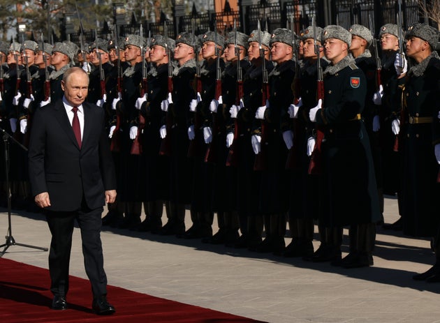 Russian President Vladimir Putin inspects Kyrgyzstan honour guard officers during the welcoming ceremony at the Yntymak Ordo Presidential Palace, on November 26, 2025 in Bishkek, Kyrgyzstan.