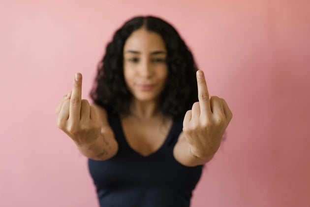 Women holding up two middle fingers.