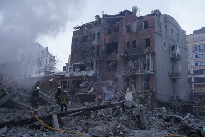 Emergency services personnel work to extinguish a fire following a Russian missile attack in Kharkiv, Ukraine, Friday, Jan. 2, 2026. (AP Photo/Andrii Marienko)
