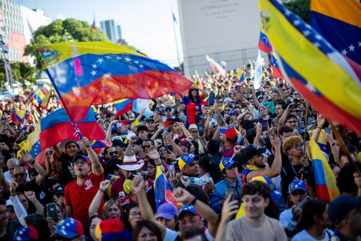 Venezuelans living in Argentina celebrate at the Obelisk in Buenos Aires on January 3, 2026, after US forces captured Venezuelan leader Nicolas Maduro. (Photo by TOMAS CUESTA / AFP via Getty Images)