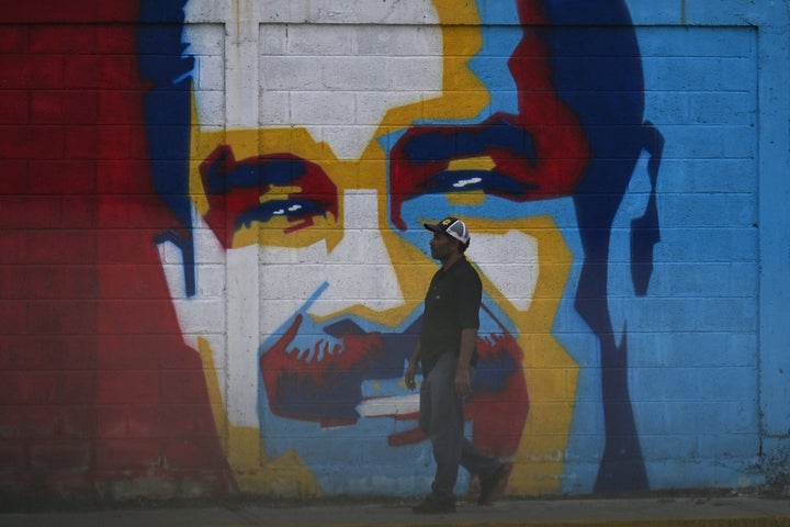 TOPSHOT - A man walks past a graffiti depicting Venezuelan President Nicolas Maduro in Caracas on January 3, 2026. President Donald Trump said Saturday that US forces had captured Venezuela's leader Nicolas Maduro after bombing the capital Caracas and other cities in a dramatic climax to a months-long standoff between Trump and his Venezuelan arch-foe. (Photo by Juan BARRETO / AFP via Getty Images)