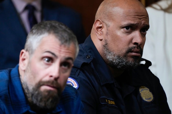 Former Washington Metropolitan Police Department officer Michael Fanone, left, and former U.S. Capitol Police Sgt. Harry Dunn, right, listen as the House select committee investigating the Jan. 6 attack on the U.S. Capitol holds its final meeting on Capitol Hill in Washington, Monday, Dec. 19, 2022.