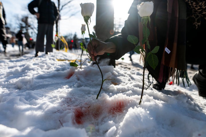 MINNEAPOLIS, MINNESOTA - JANUARY 07: A person places a flower at the site where a woman was reportedly shot and killed by an ICE agent during federal law enforcement operations on January 07, 2026 in Minneapolis, Minnesota. According to federal officials, the agent, "fearing for his life" killed a woman during a confrontation in south Minneapolis. (Photo by Stephen Maturen/Getty Images)
