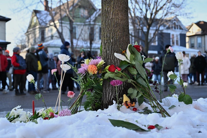 Flowers and candles are places as protesters gather near the scene of the fatal shooting involving federal law enforcement agents, Wednesday, Jan. 7, 2026, in Minneapolis.