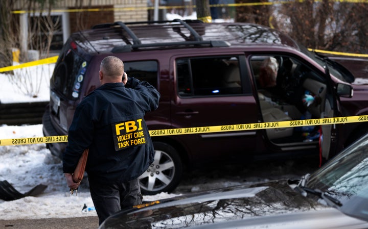 Members of law enforcement work the scene following the shooting by an ICE agent in Minneapolis. 