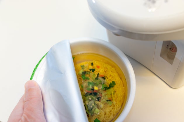 Pour hot water into the cup noodles