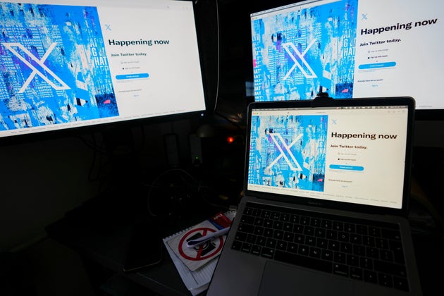 Computer monitors and a laptop display the X, formerly known as Twitter, sign-in page, July 24, 2023, in Belgrade, Serbia. 