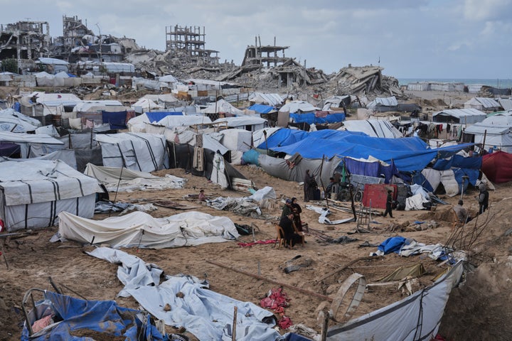 Palestinians inspect damaged tents in a displaced persons camp following Israel's attack on Gaza City on January 9, 2026. 