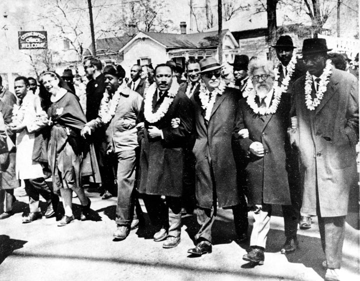 The Rev. Martin Luther King Jr. links arms with other civil rights leaders as they begin the march to the state Capitol in Montgomery from Selma, Alabama, on March 21, 1965.