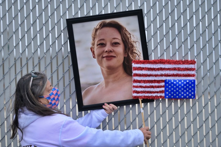 A framed portrait of Renee Nicole Good is displayed on a chain outside an immigration detention facility on Jan. 9, 2026, in Broadview, Illinois.