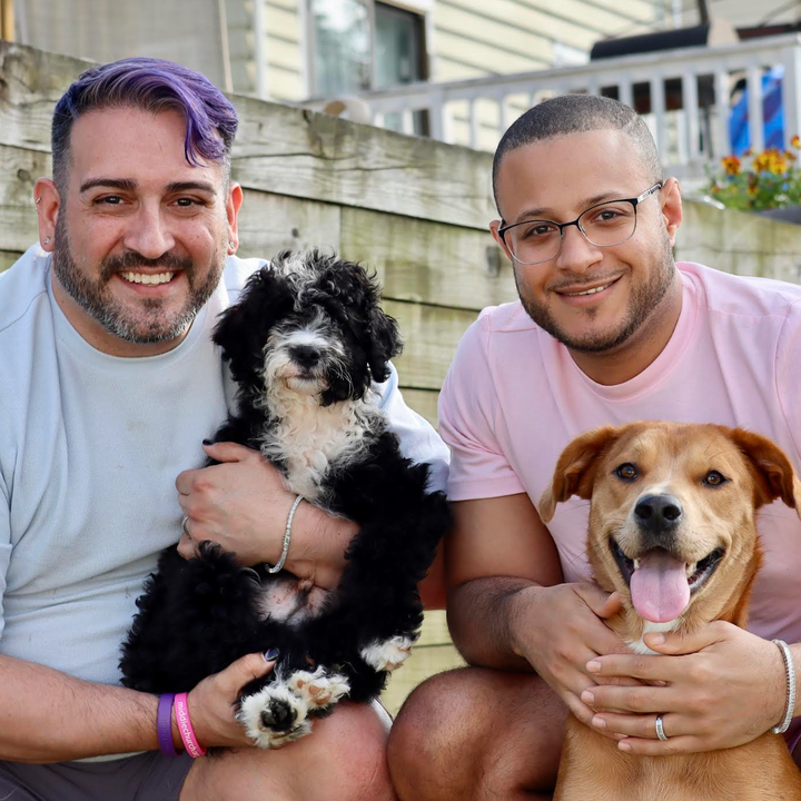 The author (left) with Allan Michael Dabrio Marrero and their dogs, Roscoe Ray (left) and Sasha Malyn (July 2025). "This is our first family photo with Roscoe Ray at our family’s home in Connecticut," the author writes.