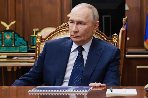 Russian President Vladimir Putin listens to Russian First Deputy Prime Minister Denis Manturov in the Kremlin in Moscow, Russia, Monday, Jan. 12, 2026. 