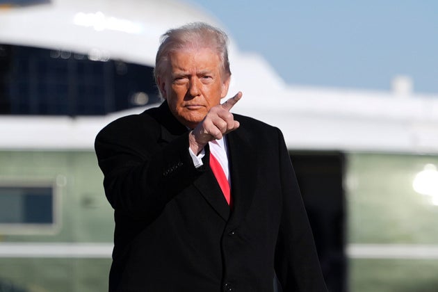President Donald Trump points as he boards Air Force One for a trip to Detroit, Tuesday, Jan. 13, 2026, in Joint Base Andrews, Md. (AP Photo/Evan Vucci)