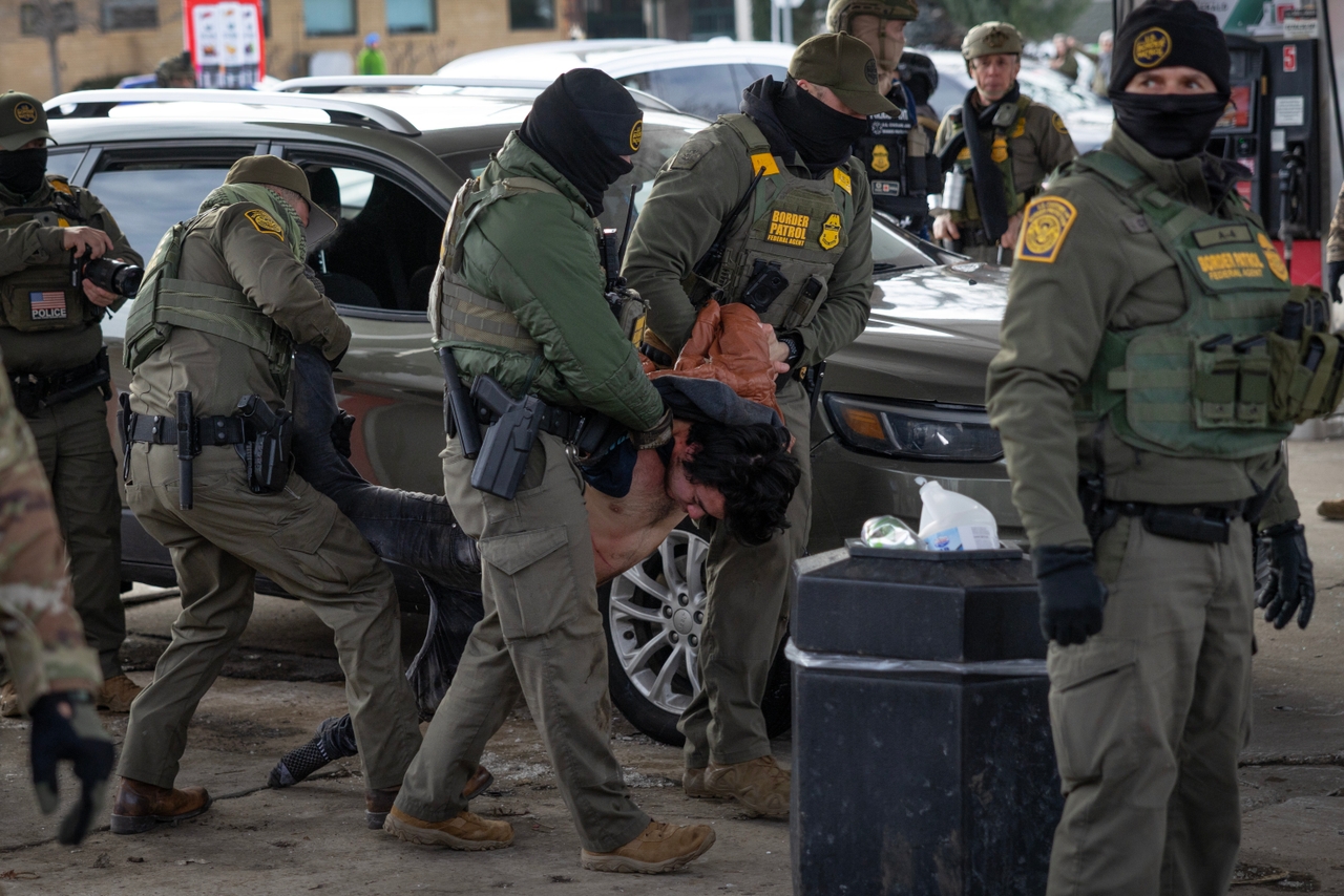 U.S. Border Patrol agents detain a man who failed to present citizenship documentation at a gas station on January 11, 2026 in St. Paul, Minnesota. When he didn't obey, they broke his car window and dragged him out, pressing him to the ground until his body went limp.