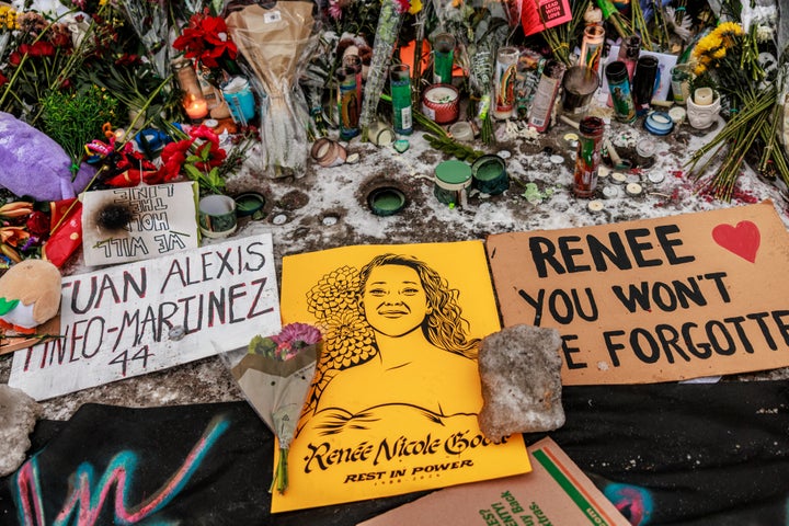 Candles, flowers and signs appear at a makeshift memorial honoring Renee Nicole Good and other victims of the police and immigration violence in Minneapolis on Sunday.