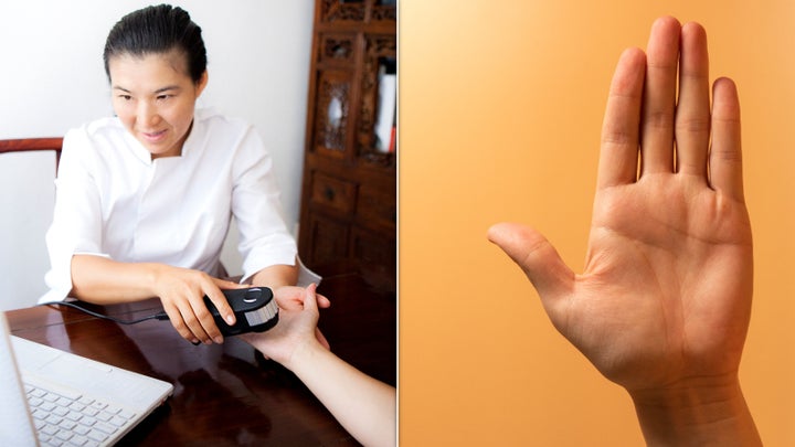 A naturopath uses OligoScan on someone's palm.