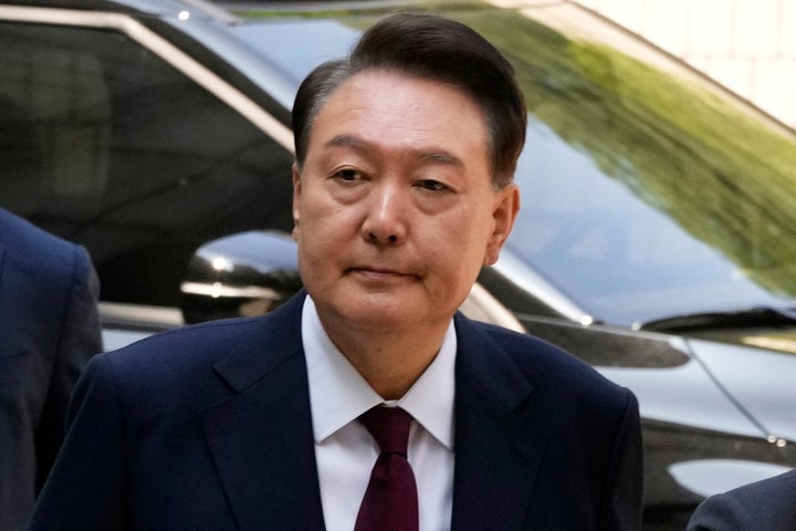 Then South Korea's ousted former President Yoon Suk Yeol who is facing charges of orchestrating a rebellion when he declared martial law on Dec. 3, arrives to attend his trial at the Seoul Central District Court in Seoul, South Korea, on May 12, 2025.