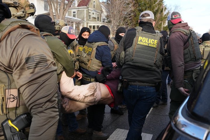 A protester is detained by Federal agents near the scene where Renee Good was fatally shot by an ICE officer last week in Minneapolis.