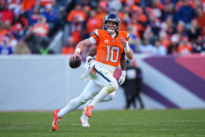 Denver Broncos quarterback Bo Nix (10) runs the ball against the Buffalo Bills in an NFL divisional playoff football game, Sunday, Jan. 17, 2026 in Denver. (AP Photo/Bart Young) ]