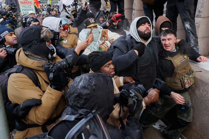 MINNEAPOLIS, MN - JANUARY 17: Pardoned January 6 defendant Jake Lang is physically confronted by a dense crowd of counter-demonstrators outside City Hall during a self-organized anti-Muslim and pro-ICE demonstration (March Against Minnesota Fraud) in Minneapolis, Minnesota, United States on January 17, 2026. Lang was confronted by several hundred counter-protesters, including anti-ICE (Immigration and Customs Enforcement) activists, who reacted strongly to his presence and his stated intent to burn a copy of the Holy Quran. Tensions in the city have remained high following recent federal immigration enforcement operations and political friction regarding Governor Tim Walz and Representative Ilhan Omar. (Photo by Madison Thorn/Anadolu via Getty Images)