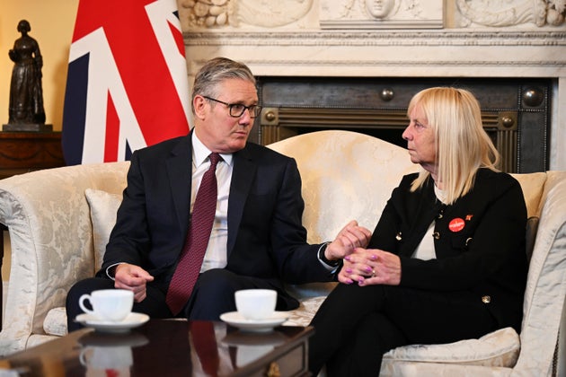 Britain's Prime Minister Keir Starmer, left, meets with Margaret Aspinall, right, at 10 Downing Street Tuesday, Sept. 16, 2025 in London, England. (Leon Neal/Pool Photo via AP)