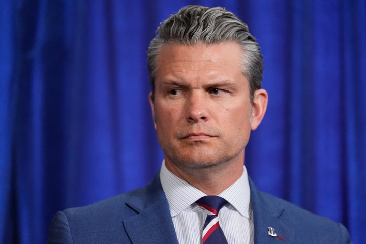 Defense Secretary Pete Hegseth listens during a news conference with President Donald Trump at Mar-a-Lago, Saturday, Jan. 3, 2026, in Palm Beach, Fla. (AP Photo/Alex Brandon)