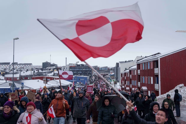 A crowd walks to the US consulate to protest against Trump's policy towards Greenland in Nuuk, Greenland, Saturday, Jan. 17, 2026. (AP Photo/Evgeniy Maloletka)
