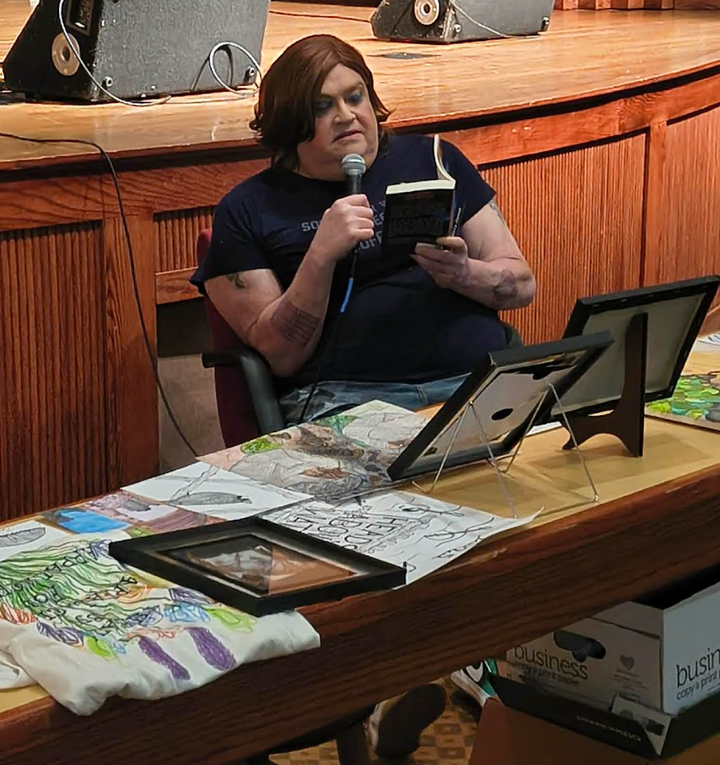 The author giving a reading of her debut novel, "Reborn in Shadows: From the Ashes," at the Art of the Potluck in Clintwood, Virginia.