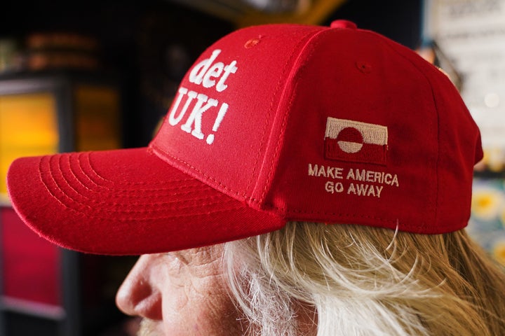Store owner Jesper Rabe Tonnesen sports a red cap for sale that he created with the slogans 